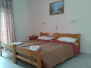 a bedroom with a bed with two pillows on it at Elpida Studio in Trapezaki