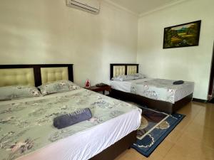 Ένα ή περισσότερα κρεβάτια σε δωμάτιο στο Villa Desa Permai +6 φωτογραφίες