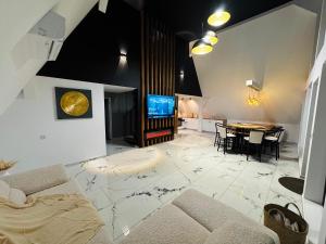 a living room with a couch and a table at Alpin Chalet & SPA in Mănăstirea Humorului +19 photos