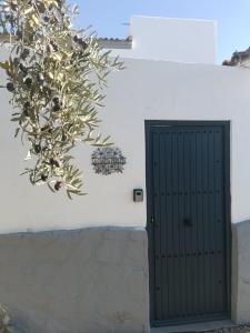 a door in a white wall with a plant next to it at La Casita Perlita in Arboleas