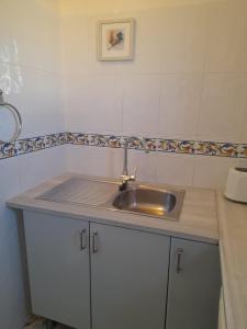 a kitchen with a sink and a counter top at La Casita Perlita in Arboleas
