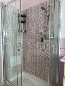 a bathroom with a shower with a glass door at Mariuccia Home in Siracusa