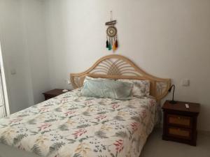 a bedroom with a bed with a wooden headboard at Mar&sun Casa Florida in Puerto del Carmen