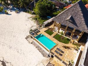 an overhead view of a house with a swimming pool on the beach at NEST in pongwe in Mdudu Mdogo