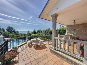an outdoor patio with a table and a fence at El mirador de Monte Bouza in Monte Bouza