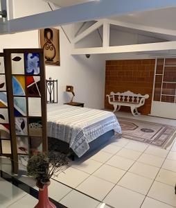a bedroom with a bed and a table in a room at Casa Prana in Bragança Paulista