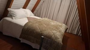 Ένα ή περισσότερα κρεβάτια σε δωμάτιο στο Chalé Rosa Linder - Alfredo Wagner-SC