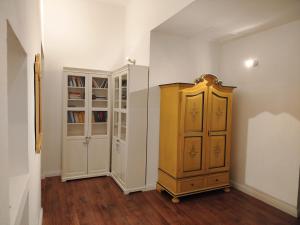 a room with a book shelf and a yellow cabinet at A Casa di Mavina - Luxury Stay in Siena