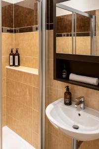 a bathroom with a sink and a shower at Budovatelska Apartment in Bratislava