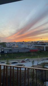 a view of a city at sunset from a balcony at Cloche d Or modern 2 bed in Luxembourg +3 photos