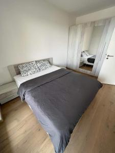 a bedroom with a bed and a mirror at Cloche d Or modern 2 bed in Luxembourg