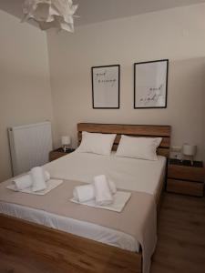 a bedroom with a large bed with towels on it at Studio4U in Néa Karváli