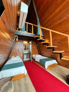 a attic room with two beds and a staircase at Loya Butik Otel Bungalov in Rize