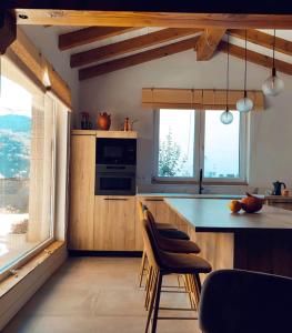 a kitchen with wooden cabinets and a table and chairs at Casa Rural Lorehonea in Artariáin +45 photos