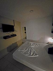 a bedroom with a bed with a tv on the wall at Casa ALCATRAZ in Cartagena de Indias