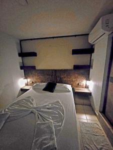 a bed in a room with a brick wall at Casa ALCATRAZ in Cartagena de Indias +22 photos