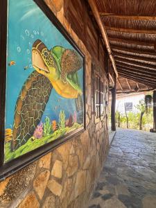 a painting of a turtle on the side of a building at Marumar in Popoyo