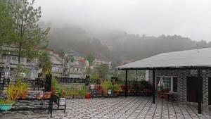 a patio with a gazebo in a city at Ranim Family Lodge Abbottabad in Abbottābād