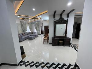 a living room with a couch and a mirror at Ranim Family Lodge Abbottabad in Abbottābād