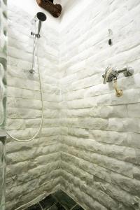 a shower in a bathroom with a stone wall at Casa Nemo - Riomaggiore, 5 Terre in Riomaggiore