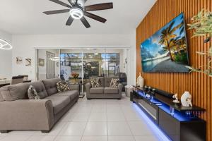 a living room with a couch and a ceiling fan at Tranquil Times Townhouse 4 bed Private Pool in Davenport