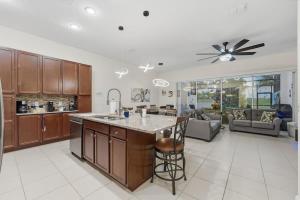 a kitchen with a large island and a living room at Tranquil Times Townhouse 4 bed Private Pool in Davenport