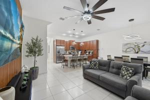 a living room with a couch and a ceiling fan at Tranquil Times Townhouse 4 bed Private Pool in Davenport