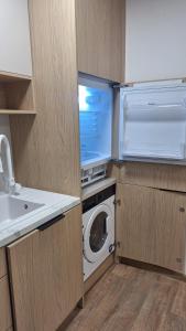 a kitchen with a refrigerator and a washing machine at Mieszkanie Armii Krajowej kawalerka basen centrum in Nowy Sącz