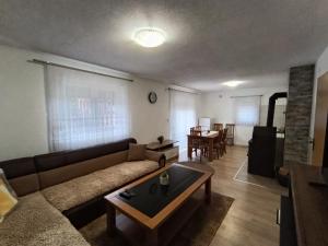 a living room with a couch and a table at Divan Vlašić in Šišava