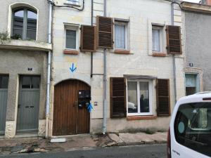 a building with a wooden door and shuttered windows at Cozy T2 - Quartier de Nantilly - Saumur in Saumur