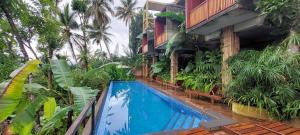 a resort with a swimming pool in front of a building at Kandy Bird Villas in Kandy
