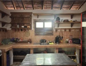 a kitchen with a counter and a sink and a window at Marumar in Popoyo +33 photos