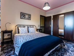 a bedroom with a large bed with a blue blanket at Casa Niebla in Alajeró