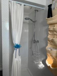 a shower with a white curtain in a bathroom at B&B Vento di Rose in Monterubbiano