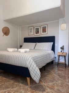 a bedroom with a large bed with a blue headboard at B&B Casa Dolce Casa Monopoli in Monopoli