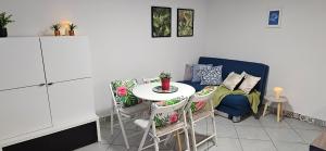 a kitchen with a table and chairs and a dining room at Willa Joanna in Gdańsk