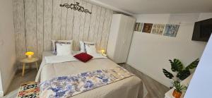a small bedroom with a bed with pillows at Willa Joanna in Gdańsk