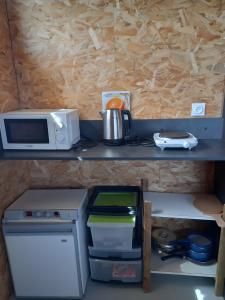 a kitchen with a counter with a microwave and a stove at Le Nid in Abbaretz +10 photos