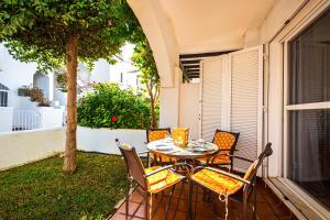 ein Tisch und Stühle auf einer Terrasse in der Unterkunft Marinas Sol - Tu hogar con jardín privado! in Vera