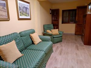 a living room with a green couch and two chairs at Casa Tajonaje in Alajeró