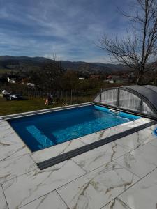 a swimming pool on top of a house at Alpin Chalet & SPA in Mănăstirea Humorului