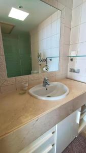 a bathroom with a sink and a mirror at Casa Micaela - Exclusive in Playa de Santiago +34 photos