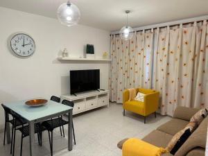 a living room with a table and a tv at Casa Cabana in El Médano
