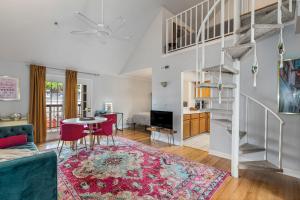a living room with a table and chairs and a spiral staircase at The Fancy Nancy in Nashville