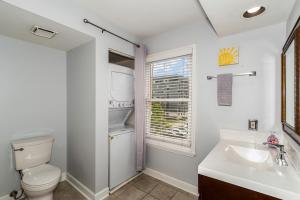 a bathroom with a toilet and a sink and a window at The Fancy Nancy in Nashville +18 photos