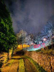 Vista noturna de um muro de pedra com uma placa que diz "walkrite" (caminhada). em Brvnare - Ranč Platan em Vrdnik