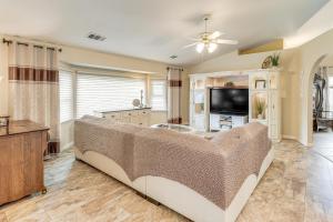a living room with a couch and a flat screen tv at Outdoor Kitchen & Patio! Central Valley Hacienda in Atwater