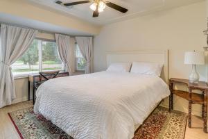 a bedroom with a white bed and a window at Outdoor Kitchen & Patio! Central Valley Hacienda in Atwater +22 photos