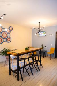 a dining room with a wooden table and chairs at VO´E in San Cristóbal de Las Casas