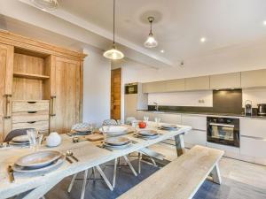 a kitchen with a table with plates on it at Chalet 3 chambres - Sauna et salle de sport - 8 pers - FR-1-685-91 in Les Gets
